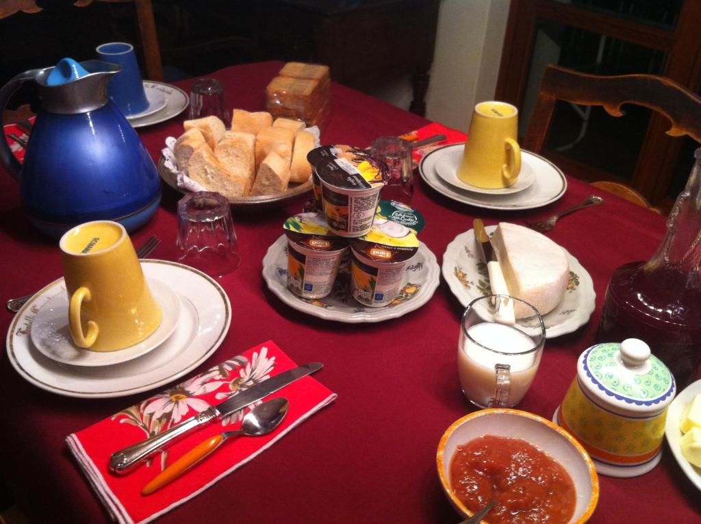 a red table with plates of food on it at B&B Le Ortensie -Lago di Como in Lierna
