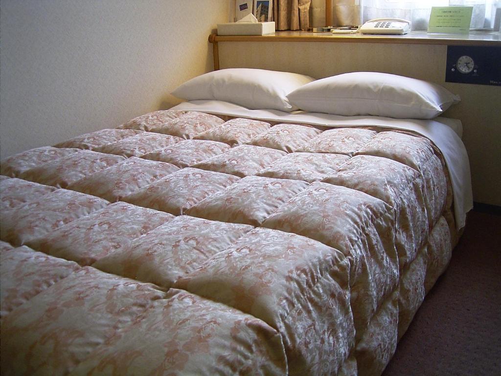 Postel nebo postele na pokoji v ubytování Ageo Tobu Hotel