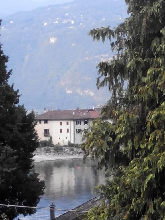 a view of a river with a building at B&B Le Ortensie -Lago di Como in Lierna