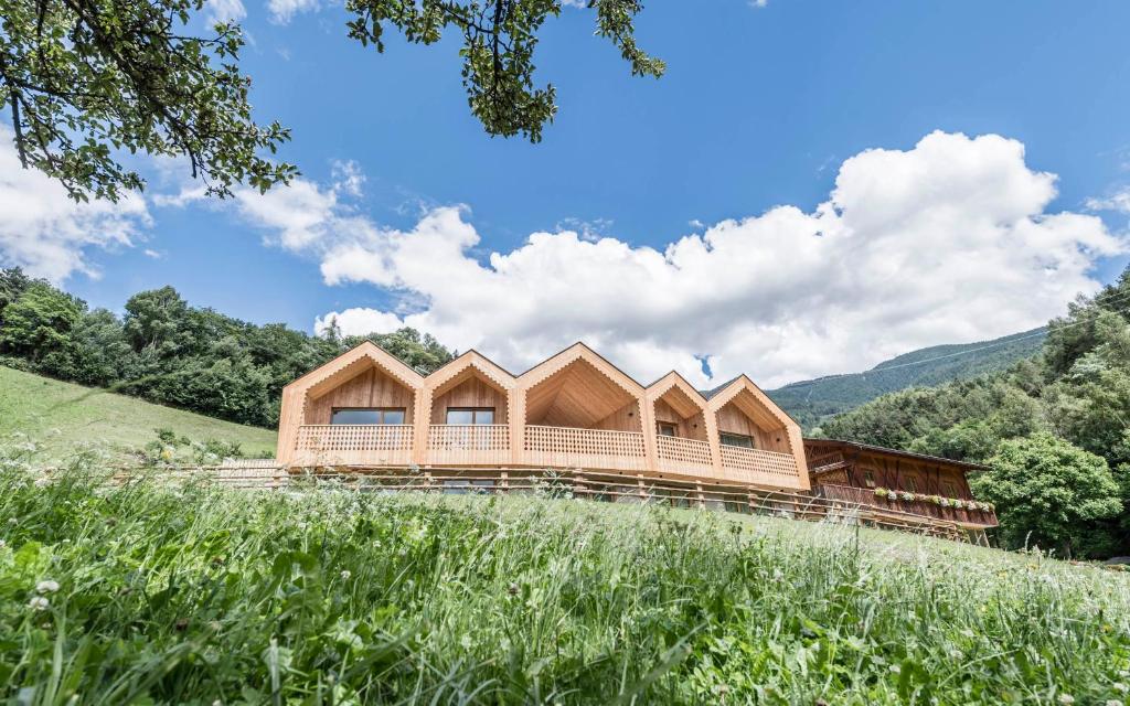 a wooden house on top of a hill at Niederthalerhof Chalets in Bressanone