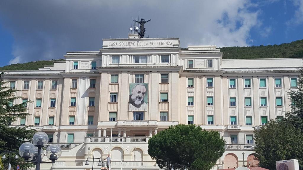 a building with a face on the front of it at Camere Santa Rita in San Giovanni Rotondo