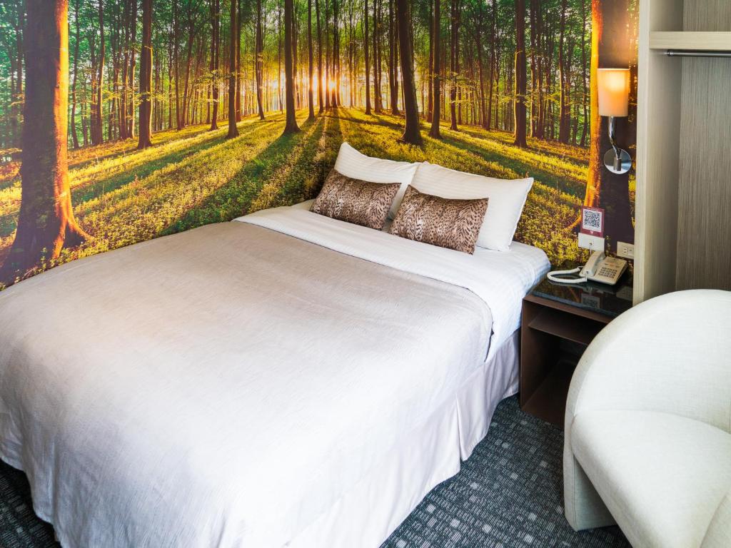 Postel nebo postele na pokoji v ubytování E-House Hotel