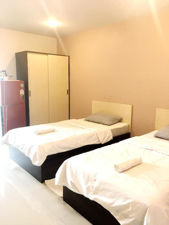 Postel nebo postele na pokoji v ubytování At Ease Hotel Suvarnabhumi