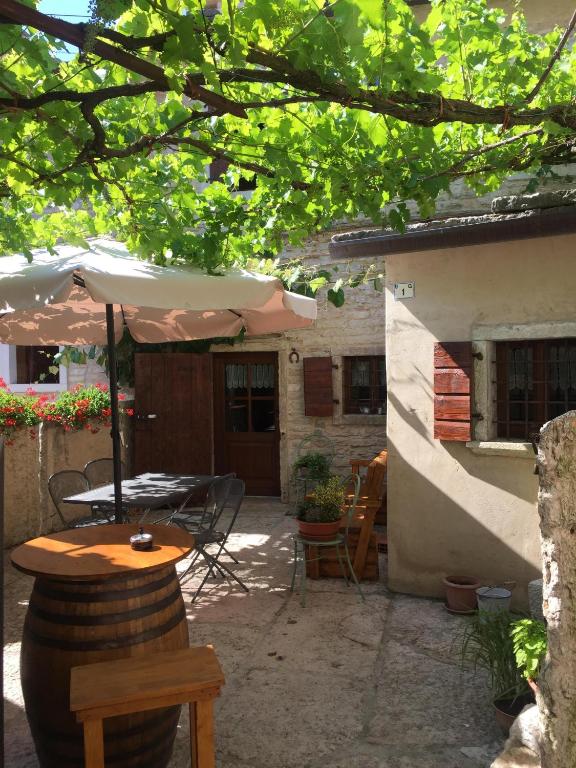 an outdoor patio with a table and an umbrella at b&b casamia in Molina