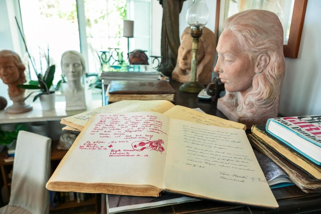 an open book on a table with a bust at La Reginella Capri in Capri