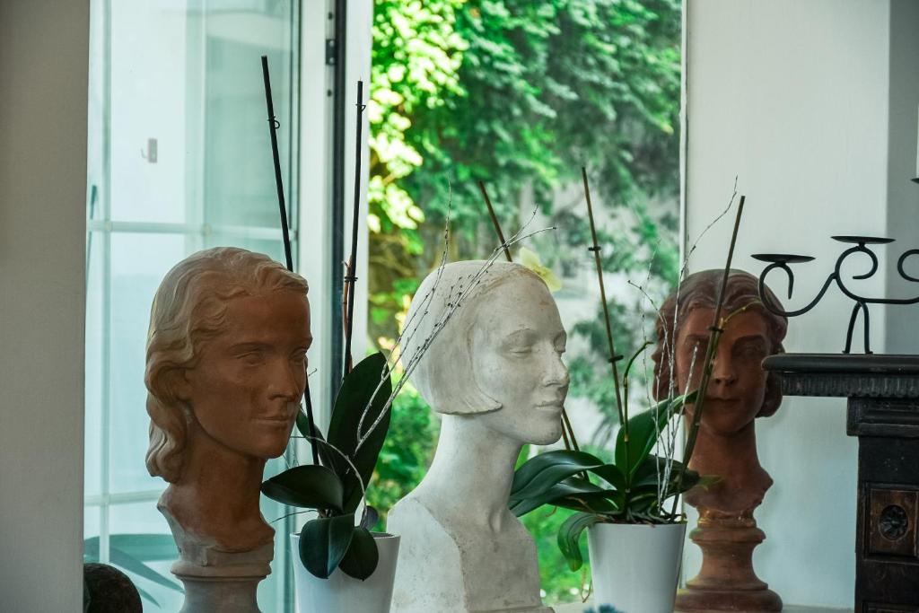 a group of busts sitting next to a window at La Reginella Capri in Capri