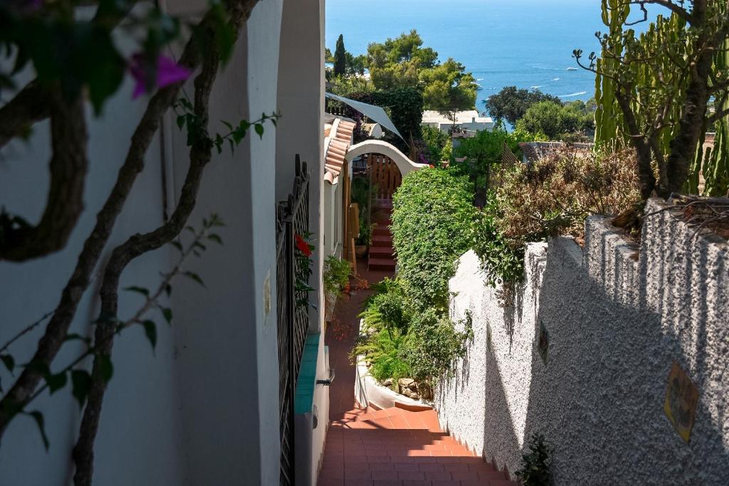 a stairway leading up to a house with a white fence at La Reginella Capri in Capri