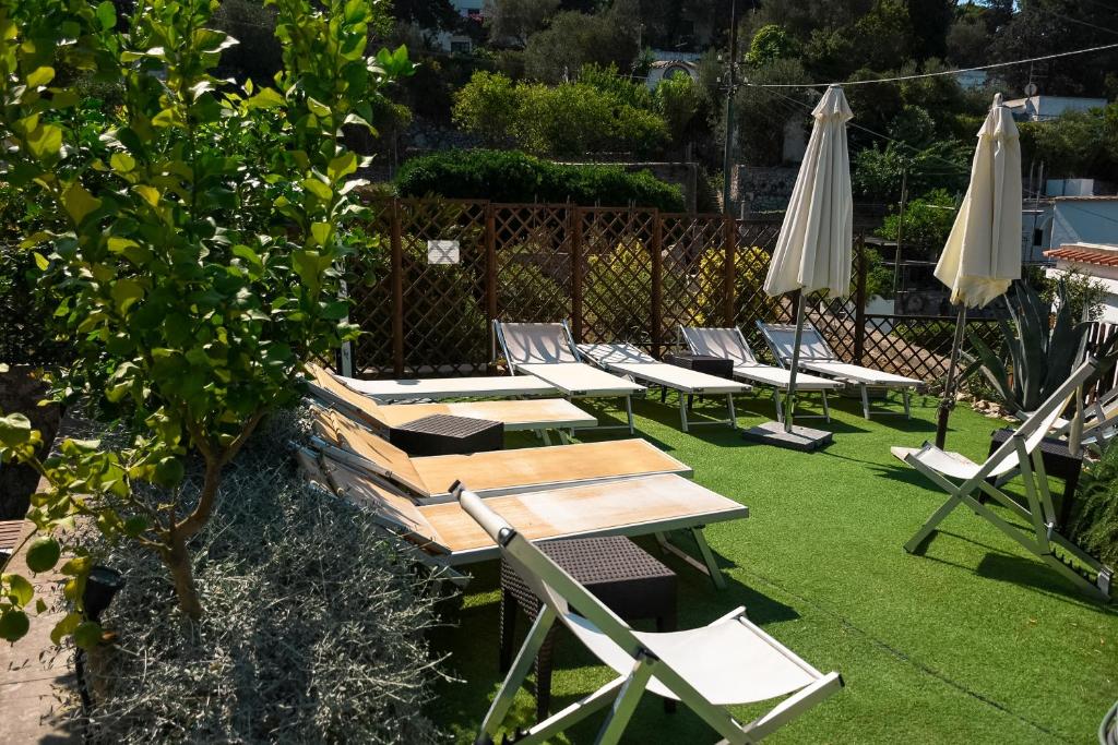 a group of chairs and tables and an umbrella at La Reginella Capri in Capri