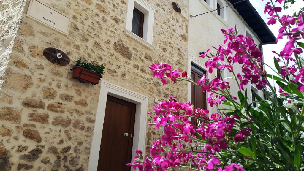 a building with pink flowers in front of it at La Palummara in San Panfilo dʼOcre