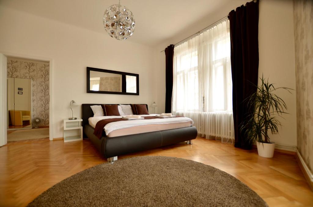 1 dormitorio con cama y lámpara de araña en Beautiful Apartments in Prague, en Praga