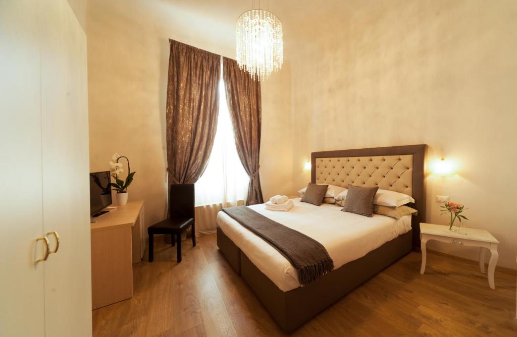 a bedroom with a large bed and a large window at La Porta del Paradiso in Florence