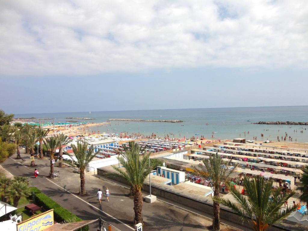 a view of a beach with a crowd of people at Hotel Svizzera in Arma di Taggia