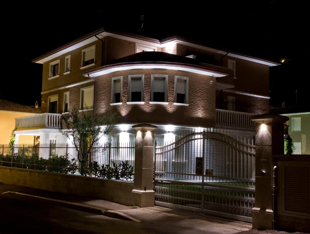 a house with lights on the front of it at night at Appartamenti Villa Ancora in Castiglione della Pescaia