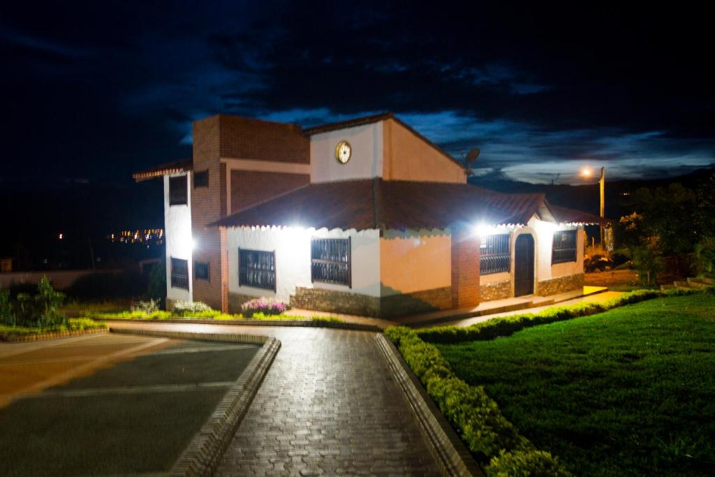 a building with a clock on it at night at Condominio Parque Baviera in Barichara