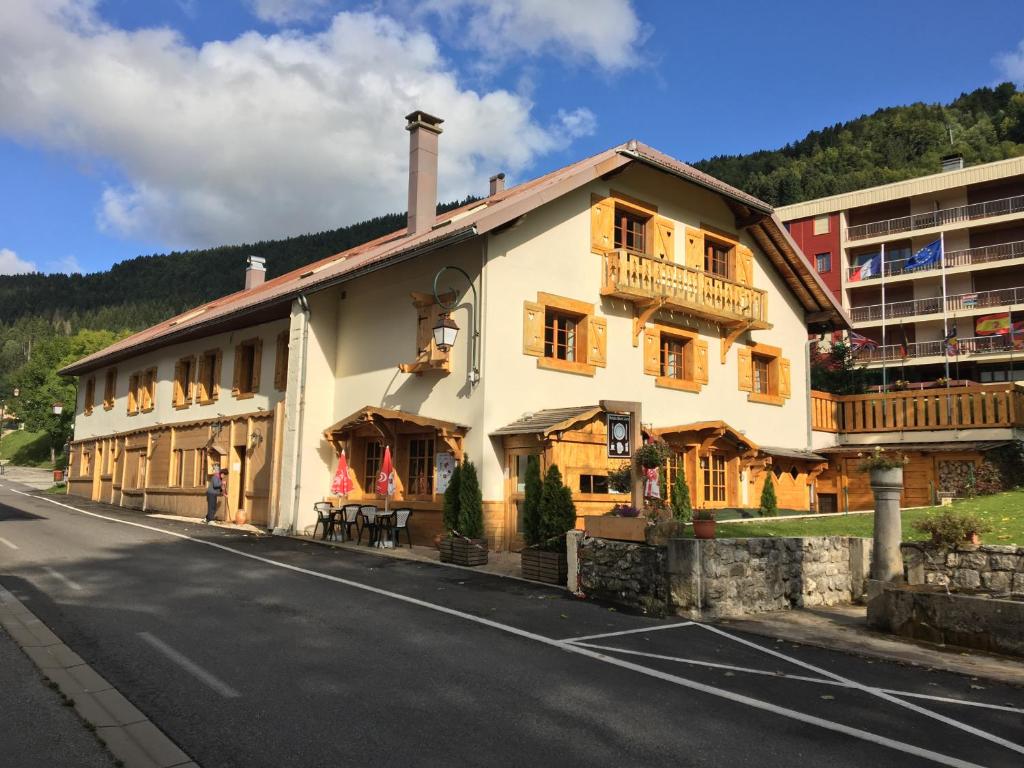 a large building on the side of a street at Relais Mont Jura Adults Only in Lélex