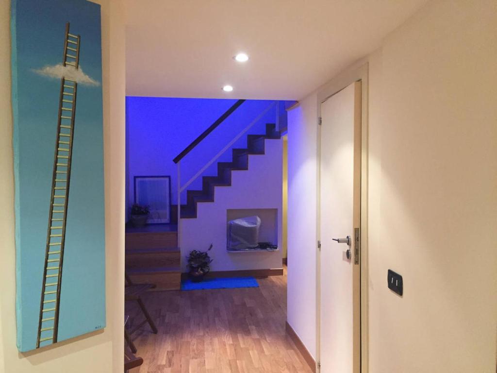 a hallway with a staircase in a house at Appartamentino 116 Via Chiaia in Naples