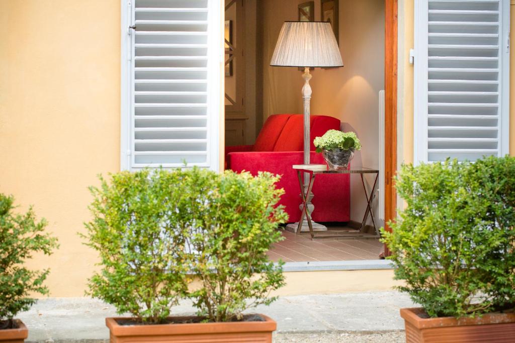 a red couch sitting on the porch of a house at MDR NumberSix Suites in Florence