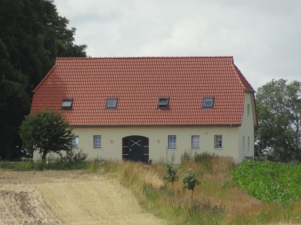 a large white house with a red roof at Weitblick in Hasselberg