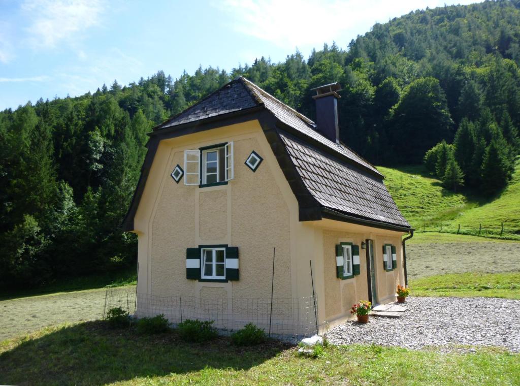 ein kleines Haus inmitten eines Feldes in der Unterkunft Jägerhaus in Hintersee