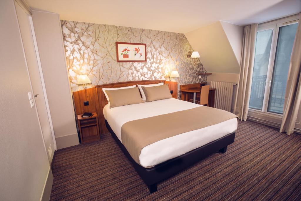 Cama ou camas em um quarto em Timhotel Palais Royal