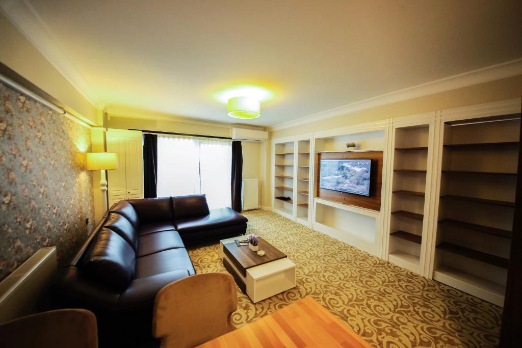 a living room with a couch and a tv at My Suit Residence in Samsun
