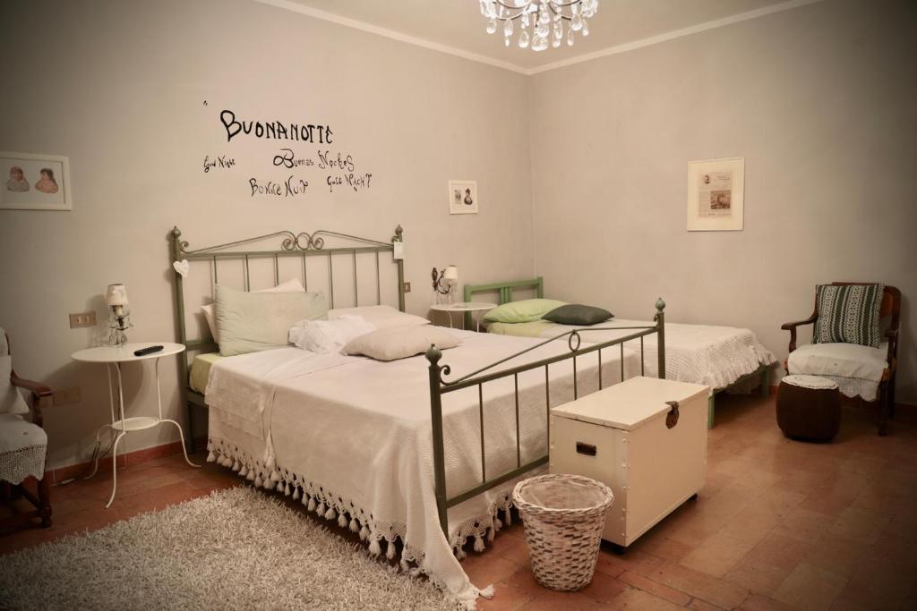 a bedroom with two beds and a chandelier at La Pausetta in Foligno