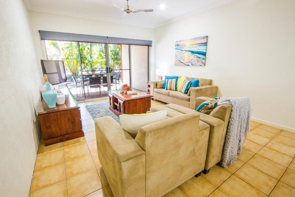 a living room with a couch and a table at Auski Hideaway in Agnes Water