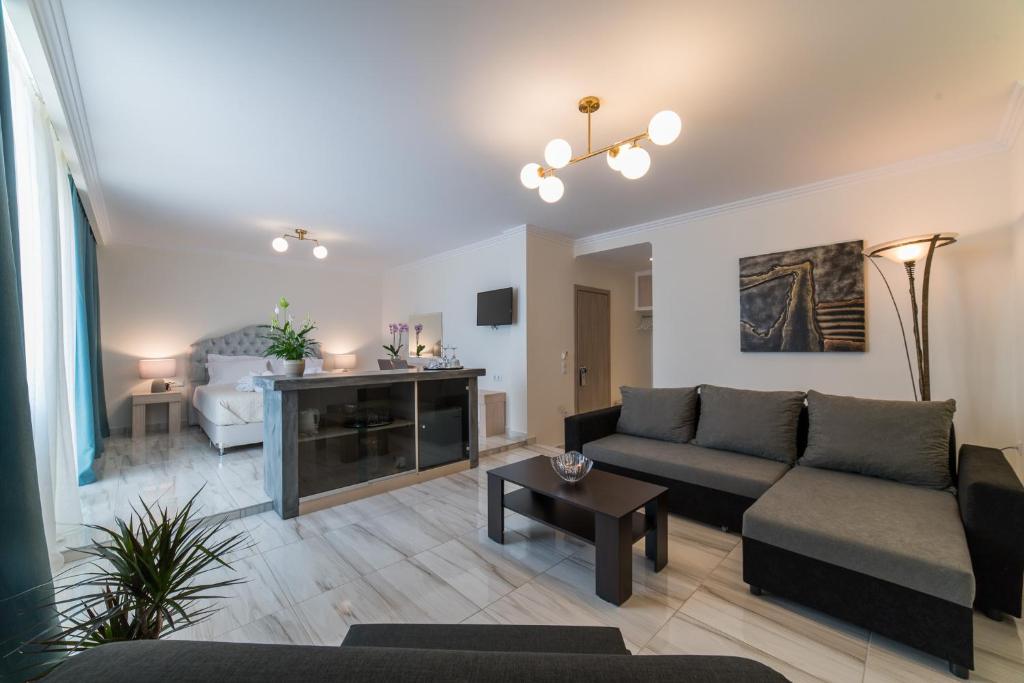 a living room with a couch and a table at Castello Boutique Rooms in Kavála