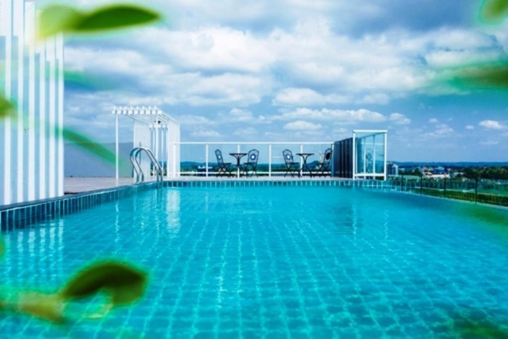 a swimming pool on the roof of a building at D@Sea Hotel in Jomtien Beach