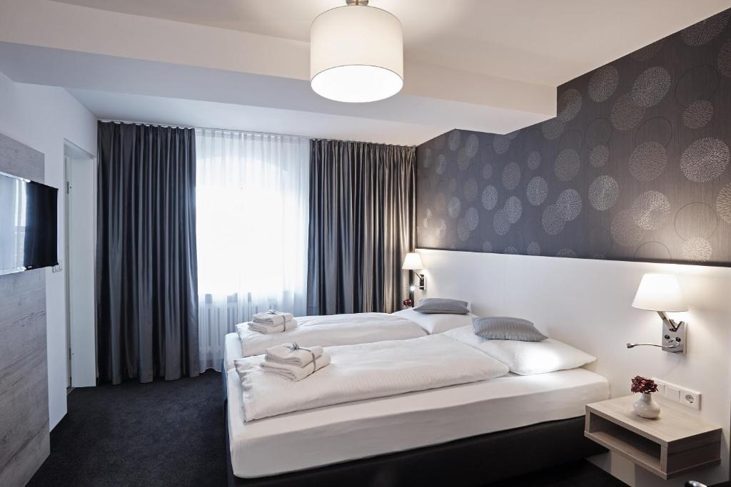 Postel nebo postele na pokoji v ubytování Hotel Alter Wirth