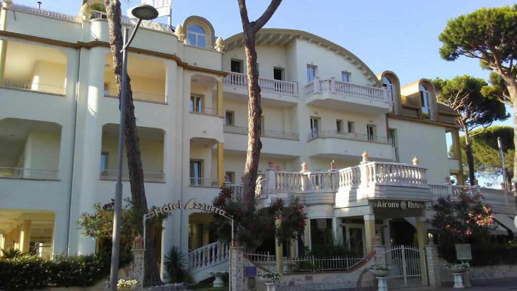 a large white building with a balcony at Hotel Azzurra in Lido degli Estensi