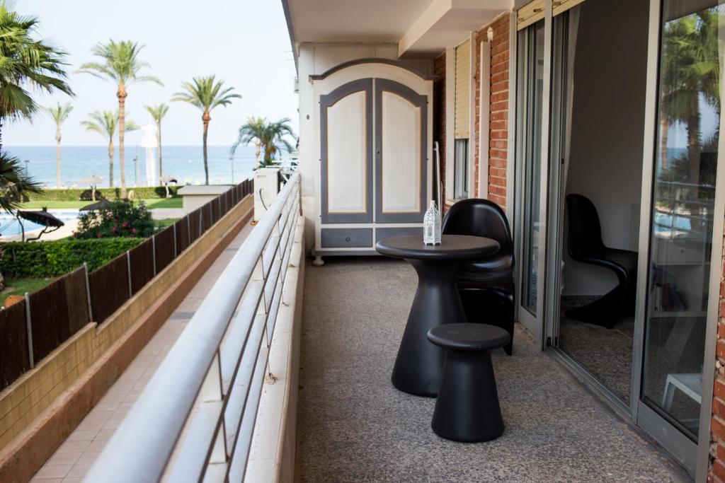 a balcony with a table and a view of the ocean at MyFlats Voramar in El Campello