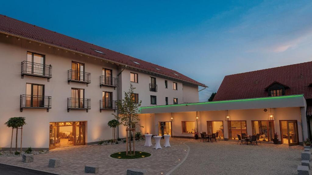 a large building with a courtyard in front of it at Gasthaus Forster am See - Eching bei Landshut in Eching