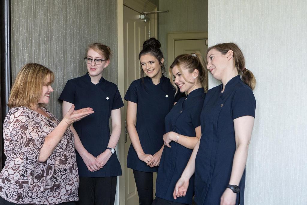 a group of women standing next to each other at Nether Abbey Hotel in North Berwick