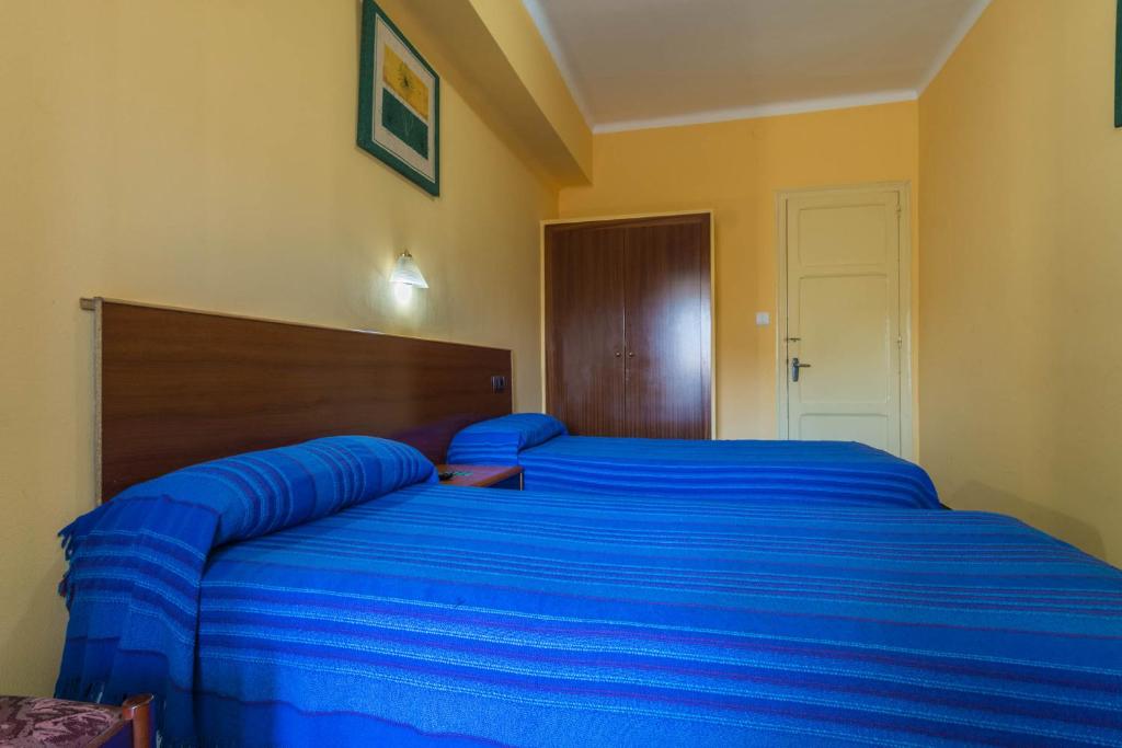 Posteľ alebo postele v izbe v ubytovaní Hostal Urgell