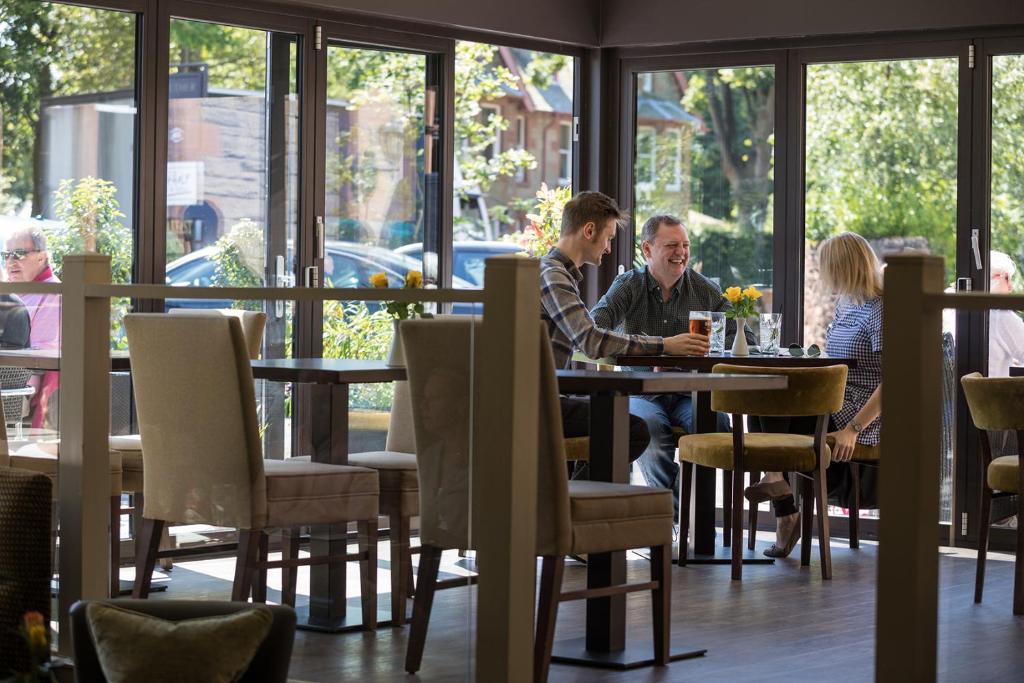a group of people sitting at a table in a restaurant at Nether Abbey Hotel in North Berwick