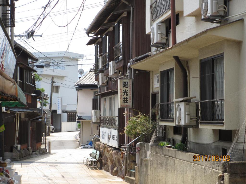 an alley in an asian city with buildings at YOKOSO Ryokan in Beppu