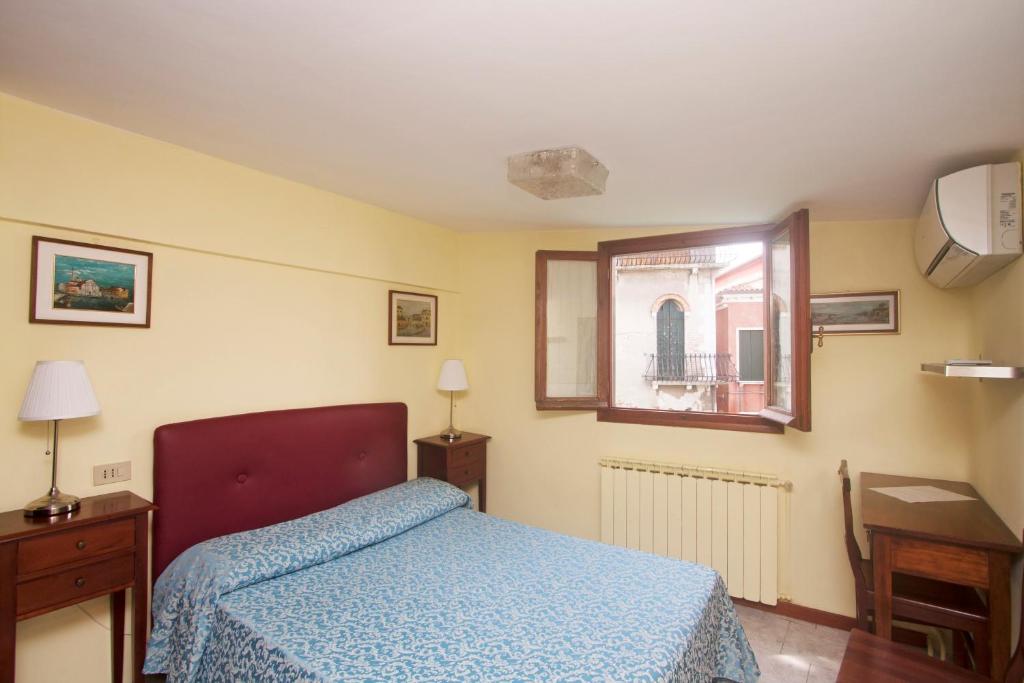 Postel nebo postele na pokoji v ubytování Hotel dalla Mora