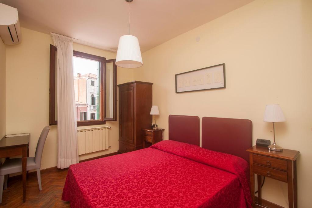 Postel nebo postele na pokoji v ubytování Hotel dalla Mora