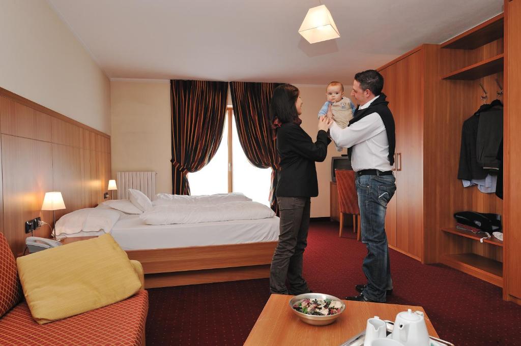 Postel nebo postele na pokoji v ubytování Hotel Touring