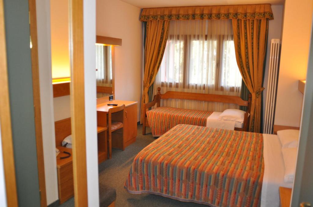 Postel nebo postele na pokoji v ubytování Liberty Hotel Malé