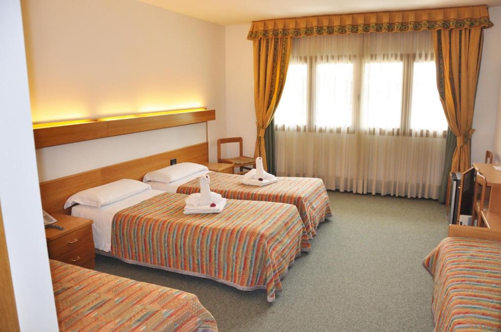 Postel nebo postele na pokoji v ubytování Liberty Hotel Malé