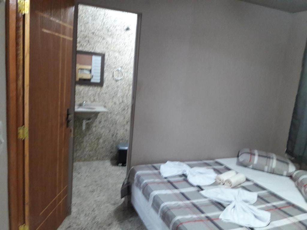 Postel nebo postele na pokoji v ubytování Hostel Falcão-Suites Privativas com Ar Condicionado