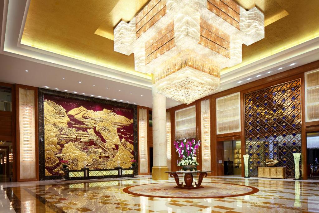 a lobby with a large chandelier in a building at Wanda Realm Taizhou in Taizhou