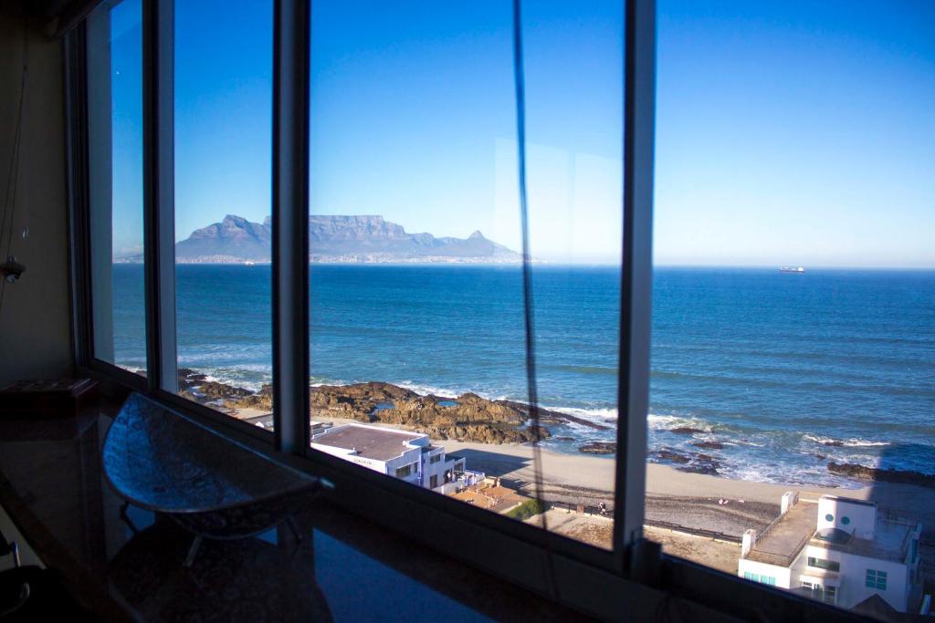 a view of the ocean from a hotel room window at Breathtaking views in Blouberg! in Bloubergstrand
