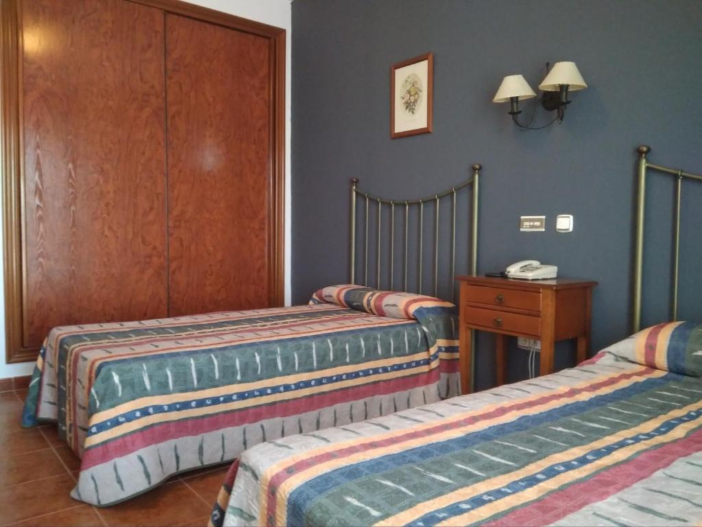 Postel nebo postele na pokoji v ubytování Hotel Alonso de Monroy