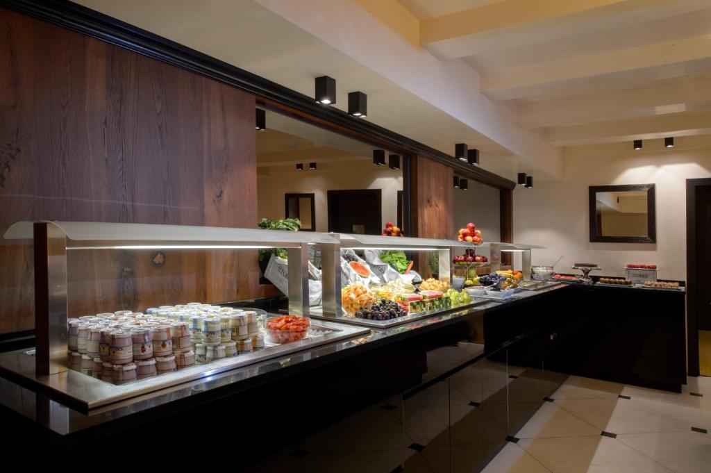 a buffet line in a hotel room with food at Palazzo Veneziano - Venice Collection in Venice