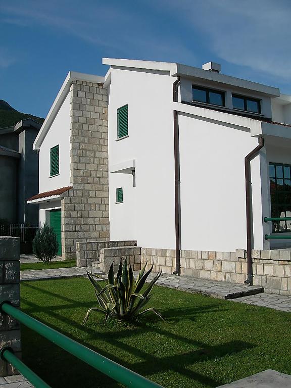 a white building with a large large billboard on it at Villa Pavlović in Herceg-Novi