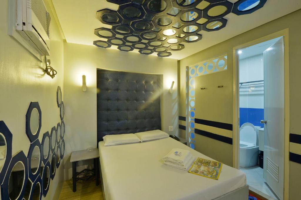 Postel nebo postele na pokoji v ubytování Hotel 99 Monumento