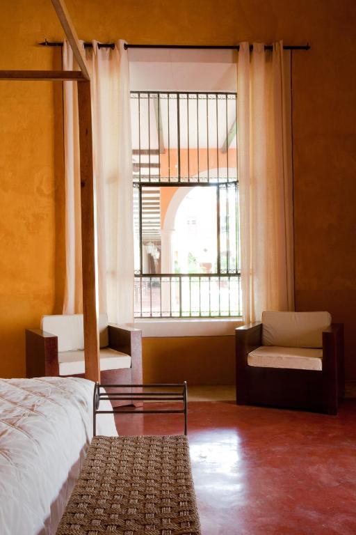 Postel nebo postele na pokoji v ubytování Hotel Hacienda Mérida VIP